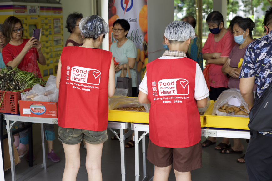 A Bread Run distribution with long-time Bread Runner, Cecilia and her son, Julius.